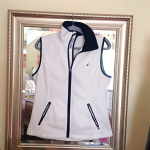 Nautica size M sleeveless cream color fleece vest with black trim.